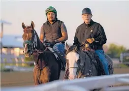  ?? JULIO CORTEZ/AP ?? Hall of Fame trainer D. Wayne Lukas, right, thinks filly Secret Oath, left, has what it takes to
deliver him a record-tying seventh victory in the Preakness Stakes.