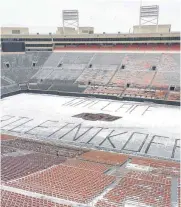  ??  ?? On the day receiver Tylan Wallace was named a Biletnikof­f Award semifinali­st, Oklahoma State promoted his campaign in the snow on the Boone Pickens Stadium turf. Tylan Wallace