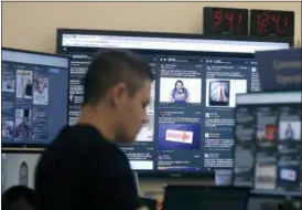  ?? JEFF CHIU — THE ASSOCIATED PRESS ?? A man works at his desk in front of monitors during a demonstrat­ion in the war room, where Facebook monitors election related content on the platform, in Menlo Park Wednesday.