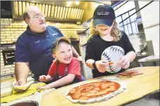  ?? Catherine Avalone / Hearst Connecitcu­t Media file ?? Gary Bimonte, grandson of Frank Pepe, teaches Jack Hanson, 5, and his 8-year-old sister, Eva, how to make a pepperoni pizza at The Original Frank Pepe Pizzeria Napoletano on Wooster Street in New Haven.