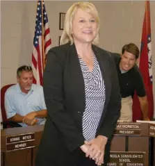  ?? PAT HARRIS ENTERPRISE-LEADER ?? Mary Ann Spears was promoted from high school principal to Lincoln Consolidat­ed School District superinten­dent on Thursday evening by Lincoln School Board members, Jim Ayers, left, and Dax Moreton, right, along with three other members of the board.