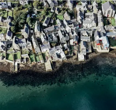  ??  ?? CLOCKWISE FROM ABOVE A bird’s eye view of Stromness; Bryher Shop & Post Office; sunset turns the cliffs at Yesnaby on Orkney a dusky shade of pink