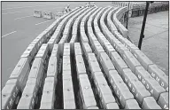  ?? AP/AARON FAVILA ?? Filipino workers arrange plastic barriers Friday in Manila to prepare for the Feast Day of the Black Nazarene, which tens of thousands of barefoot devotees are expected to attend.