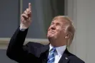  ?? Photograph: Andrew Harnik/AP ?? Donald Trump directly observes a solar eclipse.