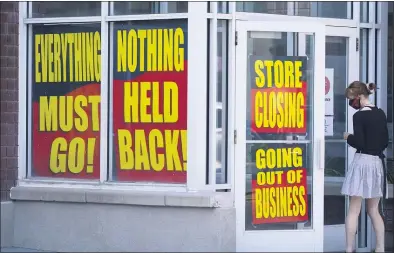  ?? RICK BOWMER — THE ASSOCIATED PRESS ?? Store closing signs are shown on a Stein Mart store in Salt Lake City over the weekend. The latest Federal Reserve survey of U.S. economic activity found generally modest gains in August but also pessimism about the future given the threats posed by the coronaviru­s.