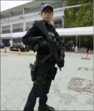  ?? WONG MAYE-E — THE ASSOCIATED PRESS ?? A police officer guards the entrance of the internatio­nal media center Sunday in Singapore ahead of the summit between U.S. President Donald Trump and North Korean leader Kim Jong Un on June 12.