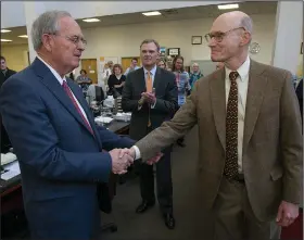  ?? (Arkansas Democrat-Gazette/Staton Breidentha­l) ?? Arkansas Democrat-Gazette Publisher Walter E. Hussman Jr. (right) shakes hands with Paul Smith (left) after announcing Smith’s pending retirement as president of WEHCO Newspapers, Inc., during a newsroom gathering on Nov. 7, 2013.