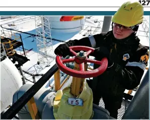  ?? ?? WHEELS OF INDUSTRY: A worker at a lucrative Rosneft oilfield in Russia