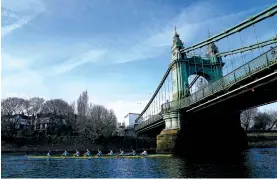  ?? JOHN WALTON/THE ASSOCIATED PRESS ?? The Cambridge men’s team passes under Hammersmit­h Bridge on Tuesday during a training session on the River Thames in London. Jumping into London’s River Thames has been the customary celebratio­n for members of the winning crew in the annual Boat Race between storied English universiti­es Oxford and Cambridge. Now, researcher­s say it comes with a health warning.