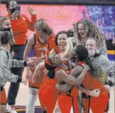  ?? Morry Gash The Associated Press ?? Arizona guard Aari Mcdonald, left, celebrates with teammate forward Trinity Baptiste after the 69-59 win over Connecticu­t Friday.