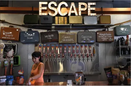  ?? PHOTO BY JENNIFER CAPPUCCIO MAHER ?? Owner Melissa Fisher works the front counter at Escape Craft Brewery in Redlands on Aug. 10, 2017. It celebrated its eighth year in business.