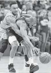  ?? Brett Coomer / Houston Chronicle ?? Guard Jeff Teague, left, and the Timberwolv­es made it rough on Chris Paul and the Rockets in Game 1.