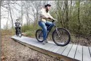  ?? NWA Democrat-Gazette/FLIP PUTTHOFF ?? Ian Lawrence (left) and Mason Lockman take a spin on a mountain bike trail built by Mason Walker for Walker’s Eagle Scout project. The trail is at Rogers New Tech High School.