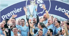  ?? EPA ?? MANCHESTER City manager Pep Guardiola lifts the Premier League trophy .
|