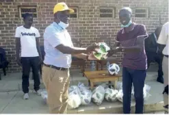  ??  ?? Lusaka Tigers chairperso­n Col Teddy Njovu (in white top) receiving the donation from Mwembeshi ward 24 councilor Kelvin Kaunda on Sunday- Picture by NOEL IYOMBWA