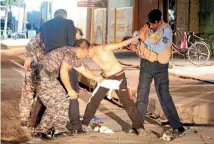  ?? PHOTO: REUTERS ?? Iraqi security forces remove a suicide bomb belt from a boy before he could detonate it in Kirkuk.