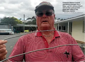  ?? PHOTO: ILLYA MCLELLAN/STUFF ?? Carterton District Council operations manager Garry Baker use two pieces of No 8 wire to find undergroun­d pipes and cables in the Wairarapa district.