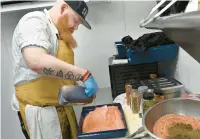  ?? ?? Dan Zegas, chef de cuisine at Sailor Oyster Bar, preps pastrami-cured salmon for a Pastrami Salmon Reuben.