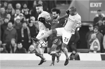  ??  ?? Manchester City’s Nicolas Otamendi (left) and Fernandinh­o (right) try to stop Liverpool’s Mohamed Salah during the English Premier League match at Anfield in Liverpool, north west England in this Jan 14 file photo. — AFP photo