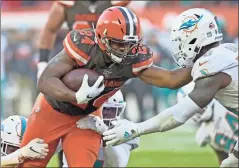  ??  ?? Cleveland Browns running back Nick
Chubb rushes for a 5-yard touchdown against the Miami Dolphins
on Sunday.