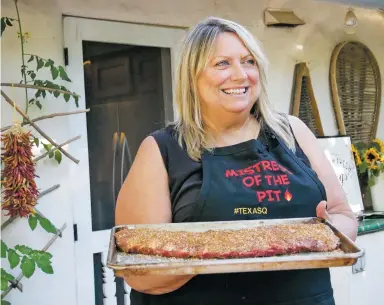  ?? PHOTOS BY MATT DAHLSEID THE NEW MEXICAN ?? ABOVE: After seasoning it with a dry rub, Cheryl Alters Jamison takes a rack of ribs to the grill. RIGHT: Alters Jamison’s finished ribs. FAR RIGHT: Alters Jamison puts a dry rub on a rack of ribs. ‘A dry rub will give you the boldest hit of flavor in the quickest amount of time,’ she says.