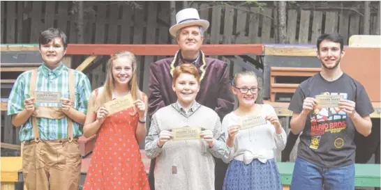  ?? PHOTOS BY AMY MELLER ?? The Bucket family includes Zachary Huseman as son Charlie, and Maggie and Taylor Williams as his parents. The five golden ticket winners are, from left, Grayson Davis as Augustus Gloop, Maggie Meller as Veruca Salt, Zachary Huseman as Charlie Bucket,...