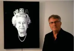  ?? Agence France-presse ?? Artist Rob Munday poses beside his portrait of Queen Elizabeth II.