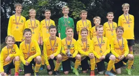  ??  ?? Pitfour U/13s celebrate with their winners’ medals and the trophy after winning their section in their first tournament at 11-a-side.