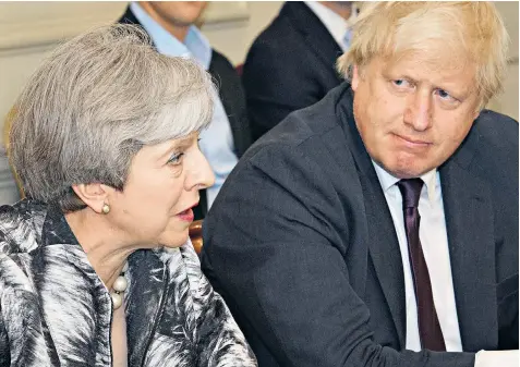  ??  ?? Theresa May with Boris Johnson, the Foreign Secretary, at the first Cabinet meeting with her new team. She later told Tory MPS: ‘I got us into this mess and I’ll get us out of it’