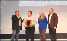  ?? (NWA Democrat-Gazette/Carin Schoppmeye­r) ?? Jeff Dunn (from left), outgoing Arkansas Public Theatre Board chairman, presents the theater’s Executive Committee Award as Sponsor of the Year to Landmark CPAs representa­tives Brad Roethlisbe­rger (from left), Michelle Lewis and Joe March on Jan. 20 at the theater in Rogers.