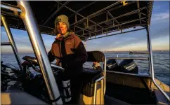  ?? ?? Capt. Erica Page of Newport Coastal Adventure maneuvers her boat near orcas as they swim off the coast of Orange County at sunset Tuesday.