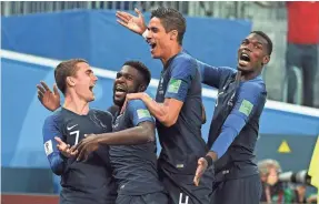  ?? TIM GROOTHUIS/WITTERS SPORT-USA TODAY SPORTS ?? Teammates celebrate the goal by Samuel Umtiti, second from left, that proved the winner Tuesday against Belgium.