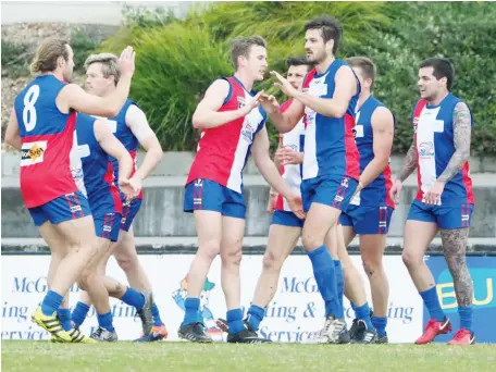  ??  ?? Gippsland team mates converge to congratula­te Bob McCallum (3rd from right) after he kicked one of his two goals for the match against Murray League on Saturday. The players, from left, are Tom Marriott, Lee Stockdale, Cade Maskell, Chris Dunne, Cody Wilson and Michael Jacobsen.