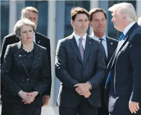  ?? EVAN VUCCI, THE ASSOCIATED PRESS ?? U.S. President Donald Trump, right, walks past Prime Minister Justin Trudeau and British Prime Minister Theresa May after speaking Thursday at a ceremony held to unveil artifacts from New York’s World Trade Center and the Berlin Wall for the new NATO...