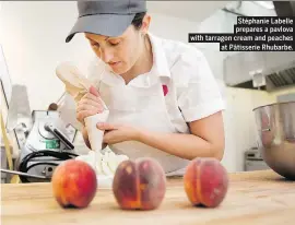  ??  ?? Stéphanie Labelle prepares a pavlova with tarragon cream and peaches at Pâtisserie Rhubarbe.