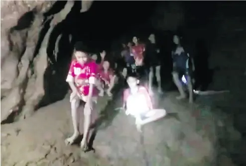  ?? THAI NAVY SEAL VIA THE ASSOCIATED PRESS ?? Rescuers found all 12 boys and their soccer coach alive deep inside a partially flooded cave in northern Thailand late Monday, more than a week after they disappeare­d. Serious challenges remain for both the group and their rescuers.