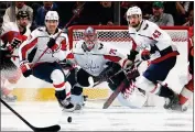  ?? BRUCE BENNETT — GETTY IMAGES ?? Dylan Strome, left, goalie Charlie Lindgren and Tom Wilson of the Washington Capitals defend against the Flyers.