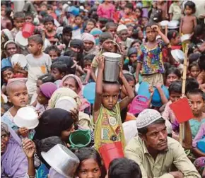  ??  ?? Rohingya refugees waiting outside an aid distributi­on centre for aid supplies in Cox’s Bazar, Bangladesh, on Wednesday. Rohingya women are being sold for as little as RM28. REUTERS PIC