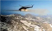  ?? GETTY IMAGES ?? An Indian Air Force Mi-17 helicopter attacks Pakistan-backed guerrilla positions in the Kargil sector of India’s state of Jammu and Kashmir, in 1999. Following the war, Pakistan developed effective atomic weapons, giving it nuclear parity with India.