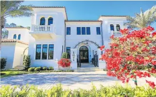  ?? PHOTOS BY JACOB LANGSTON/STAFF PHOTOGRAPH­ER ?? The exterior and living and dining rooms of one of the luxury homes for sale in Four Seasons Private Residences Orlando in Disney’s Golden Oak community are shown here. The starting price for the homes is $5 million.