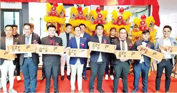  ??  ?? Ansibin (front, second left), Lee (front, third left), Tsang (front, third right) and Chan (front, second right) with Loo (front, fourth right) and Lim (front, fourth left) at the launch of EZY Box, Malaysia's first unmanned store, at KK Times Square yesterday.