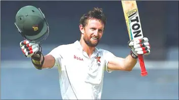  ??  ?? WHAT A GOOD FEELING . . . Zimbabwe batsman Craig Ervine raises his bat after scoring a century on the opening day of the only Test against Sri Lanka in Colombo yesterday. — AFP