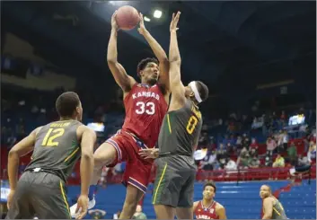  ?? The Topeka Capital-Journal via AP photo ?? Kansas forward David McCormack shoots as he is defended by Baylor’s Flo Thamba during the second half of the Jayhawks’ 71-58 victory Saturday.