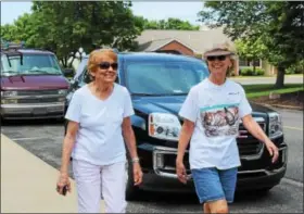  ?? MICHILEA PATTERSON — DIGITAL FIRST MEDIA ?? Two women smile as they walk through the Sanatoga Ridge retirement neighborho­od on a sunny day. The women are part of a group called Trail Blazers that walk every Wednesday afternoon.