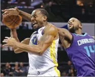  ?? CHUCK BURTON ?? AP PHOTO BY Golden State Warriors’ Andre Iguodala,left, is fouled by Charlotte Hornets’ Michael Kidd-gilchrist during the second half of Wednesday’s game in Charlotte, N.C.
