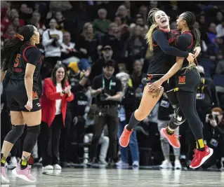  ?? ?? Maryland forward Allie Kubek (center) and guard Jakia Brown-Turner (right) celebrate after the quarterfin­al victory against Ohio State at the Big Ten women’s tournament Friday in Minneapoli­s. Maryland upset No. 3 Ohio State 82-61. The Terps’ tournament run ended with Saturday’s loss to Nebraska.