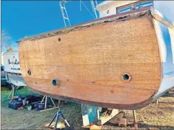  ?? AP-David Bigelow ?? Above and below:Part of a boat that is being retrofitte­d to replicate the boat from the movie Jaws. A group of ocean lovers and movie buffs is building a replica of the boat, the Orca, for use as a conservati­on tool.