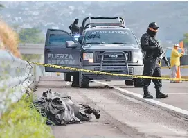  ?? JOSÉ LUIS DE LA CRUZ/EFE ?? Policías resguardan las bolsas con restos humanos en Chilpancin­go.