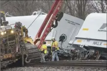  ?? Mandi Wright / Detroit Free Press photo via AP ?? An emergency crew works at the site of a Norfolk Southern train derailment in Van Buren Township, Mich., near Detroit, on Thursday.