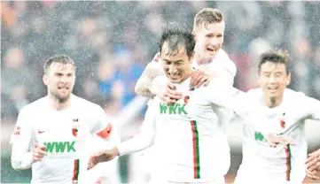  ?? — AFP photo ?? Augsburg's South Korean forward Ji Dong-won scored twice on Friday.